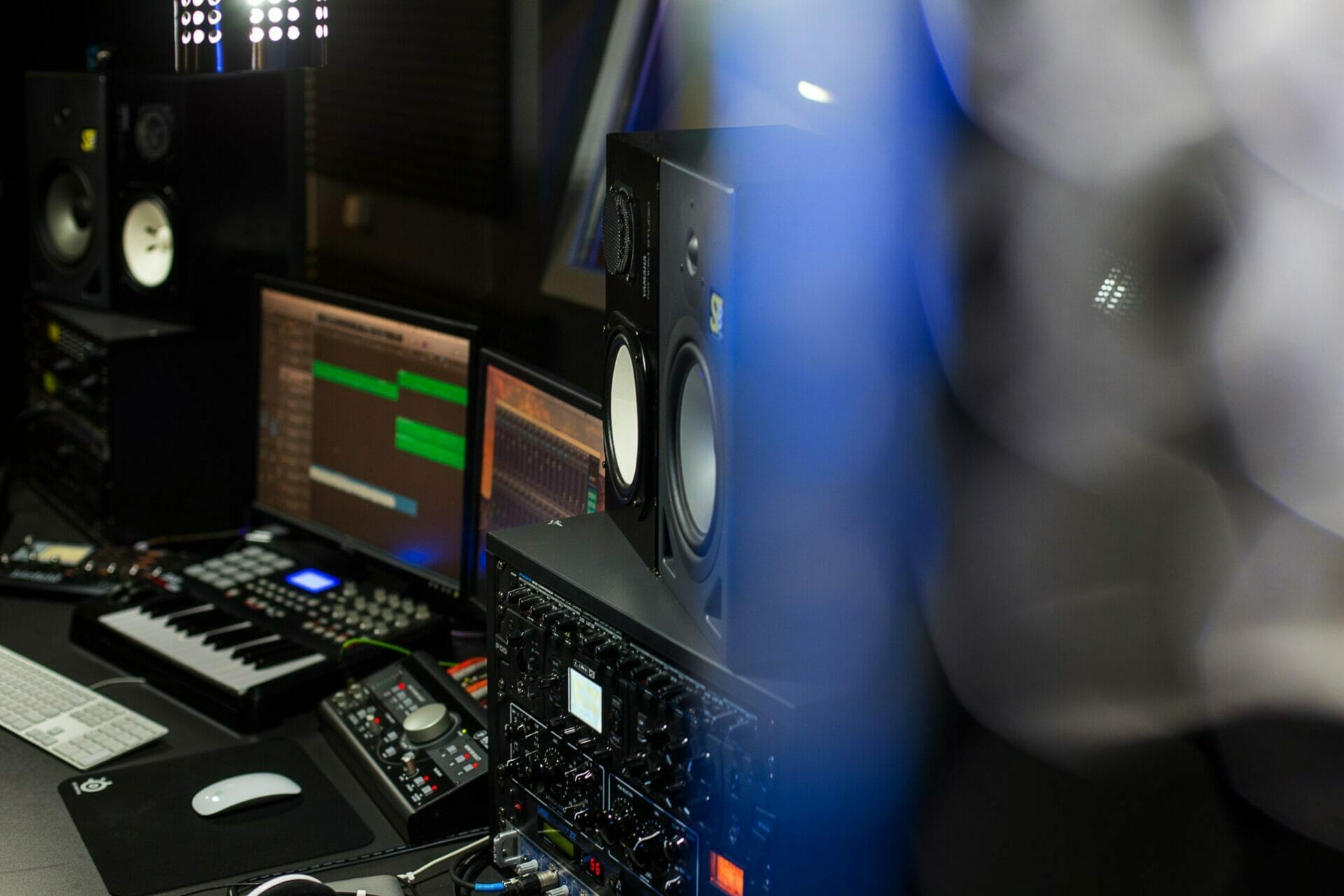 Music production equipment including speakers, an audio interface, and a midi keyboard is ready for musicians in the MOON MUTT Recording Studio setup. | MOON MUTT Recording Studio